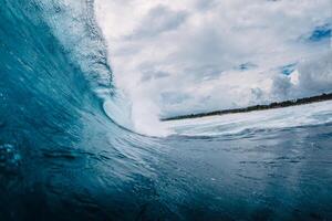 Big ocean blue wave. Breaking barrel wave photo