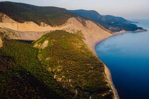 Aerial view of coastline with sea, mountains, canyon and cliffs with sunset photo