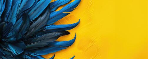 Blue feathers on a bright yellow background. Abstract colorful background with copy space photo