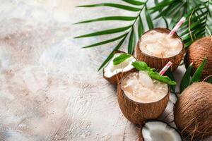 Cocktail in coconut with mint petals on a summer background with palm tree leaves. Copy space photo