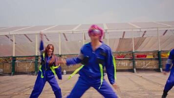 Group of workers in uniforms doing a coordinated dance outdoors. video