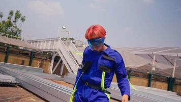 Stylish person with colorful hair wearing reflective sunglasses against a clear sky. video