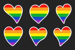 Set of stickers of rainbow hearts isolated on a dark background. Pride month stickers vector