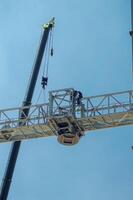 construction workers who weld and join iron at height with telescopic cranes, Indonesia, 16 May 2024. photo
