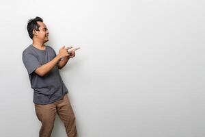 an asian man in gray is pointing something aside with copy space isolated on white background photo