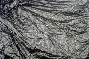 textura de negro el plastico bolso estropeado. Copiar espacio foto