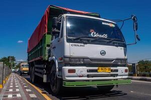 a large dump truck for the mining industry passing on the highway, Indonesia, 16 May 2024. photo