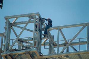 construction workers who weld and join iron at height, Indonesia, 16 May 2024. photo