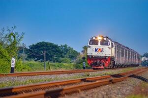 a series of Indonesian executive class trains speeding on double tracks, Indonesia, 4 May 2024. photo