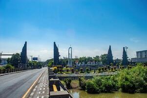 a monument and border gate between the city of Surabaya and Gresik Regency with the signature or name of Gresik Regency, Indonesia, 16 May 2024. photo