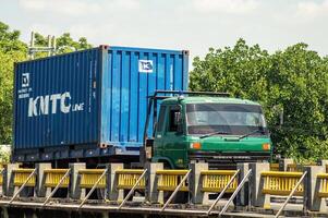 a trailer truck carrying logistics or shipping containers, Indonesia, 16 May 2024. photo