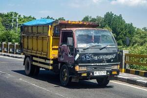 a small and old garbage truck, Indonesia, 16 May 2024. photo