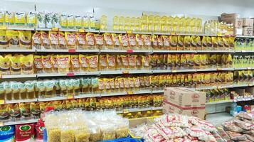 Semarang, Indonesia - May 8, 2024 - various brands of cooking oil products in the supermarket window photo