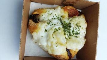 Tasty stuffed pocket, Soft bread filled with savory sausages with a special cheesy and creamy sauce photo