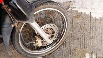 The front wheel of a motorbike seen from above photo