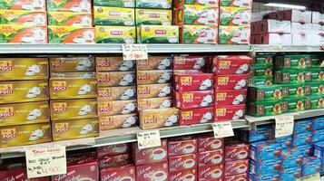 Semarang, Indonesia - May, 2024 - Boxed tea is sold in a window, product display case in a supermarket photo