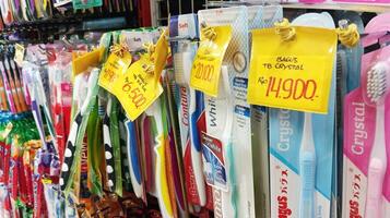 Semarang, Indonesia - May, 2024 - Various brands of toothbrushes are sold in shop windows photo