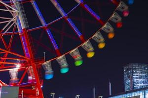 A ferris wheel at the amusement park in Tokyo at night photo