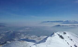 escénico ver desde ljuboten pico en un soleado invierno día a el brumoso paisaje foto