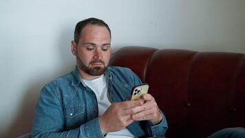 Man Relaxing At Home With His Smartphone video