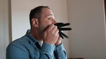 Man Blowing Air Into Plastic Gloves video