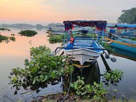 View of several boats leaning on the edge of the reservoir photo