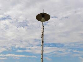 Street lighting against cloudy sky photo