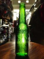 green glass bottle against sunlight photo