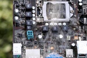 Clean the computer motherboard with water and detergent. Choose focus on water photo