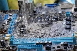 Clean the computer motherboard with water and detergent. photo