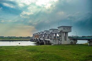 landscape of the dam or hoover on the Bengawan Solo River in the afternoon with a cloudy sky at dusk after rain photo