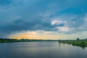 landscape of the natural scenery of the Bengawan Solo River in the afternoon with cloudy twilight photo