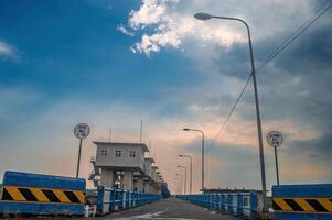 a road on a dam on the Bengawan Solo River in the afternoon to control flood water. Translation Speed Max and Load Max photo