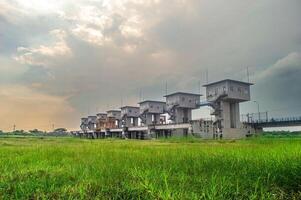 landscape of the dam or hoover on the Bengawan Solo River in the afternoon with a cloudy sky at dusk after rain photo