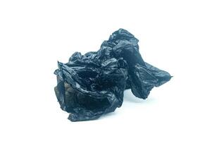 black plastic bag crumpled on white background. Copy space photo