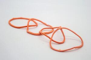 Rubber bands looped together in a chain. white background copy space photo