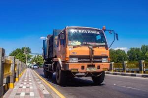 a large garbage truck passing on the highway, Indonesia, 16 May 2024. photo