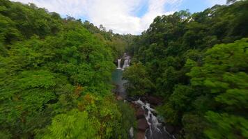 dinâmico fpv voar sobre rio e cachoeiras dentro a exuberante selva dentro Tailândia video