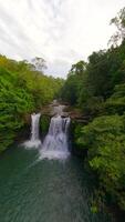 Dynamic FPV flight over river and waterfalls in the lush jungle in Thailand video