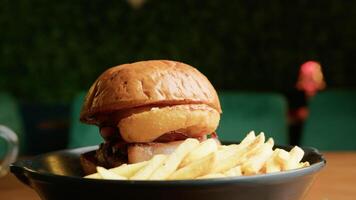 A Gourmet Burger Dish Served With Fries video