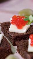 Fish Red black caviar on Black Borodino bread with lemon beautifully served in a restaurant tasting Rich life on a plate of lettuce and olives video