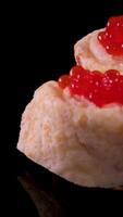 Sandwiches with red caviar on dark background video