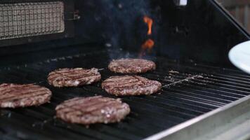 hamburger food meat fried professional chef preparing with black gloves hands top down close up slow motion video