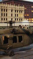 Military Helicopter Parked at Large Building video