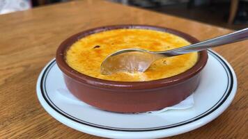 creme brulee con zucchero Crosta cucchiaio rubinetti croccante caramello Crosta su creme brulée. francese dolce o spagnolo creme catalana. rotte, Cracked Crosta di tradizionale francese crema dolce. bruciato Trinità video