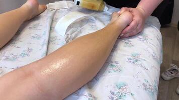 Waxing legs Depilation of legs with sugar paste or Shugaring. Beauty saloon. video