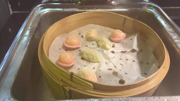 Steamed buns with filling. Vietnamese steamed pies Steamed meat bun on hot steam pot, Hot steamed pork bun in bamboo steamer. container. video