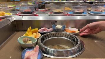 Tom Yum soup Buffet prepare soup Vietnamese Asian cuisine Tom Yang cook Near many products choose different ingredients add boiling water to broth red fish octopus seafood meat and vegetables video