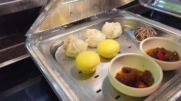 Steamed buns with filling. Vietnamese steamed pies Steamed meat bun on hot steam pot, Hot steamed pork bun in bamboo steamer. container. video