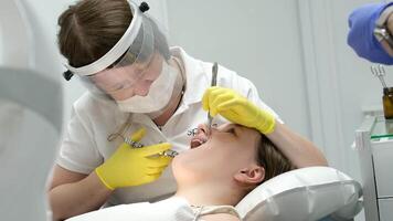 Dentistas mãos dando anestésico injeção para fêmea paciente durante dental procedimento dentro clínica. médico fazer anestésico injeção para mulher dentro odontologia escritório. dental tratamento conceito. fechar-se. video